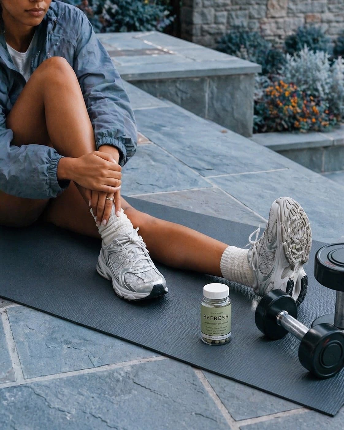 REFRESH beside training gear on stone steps in morning light.
