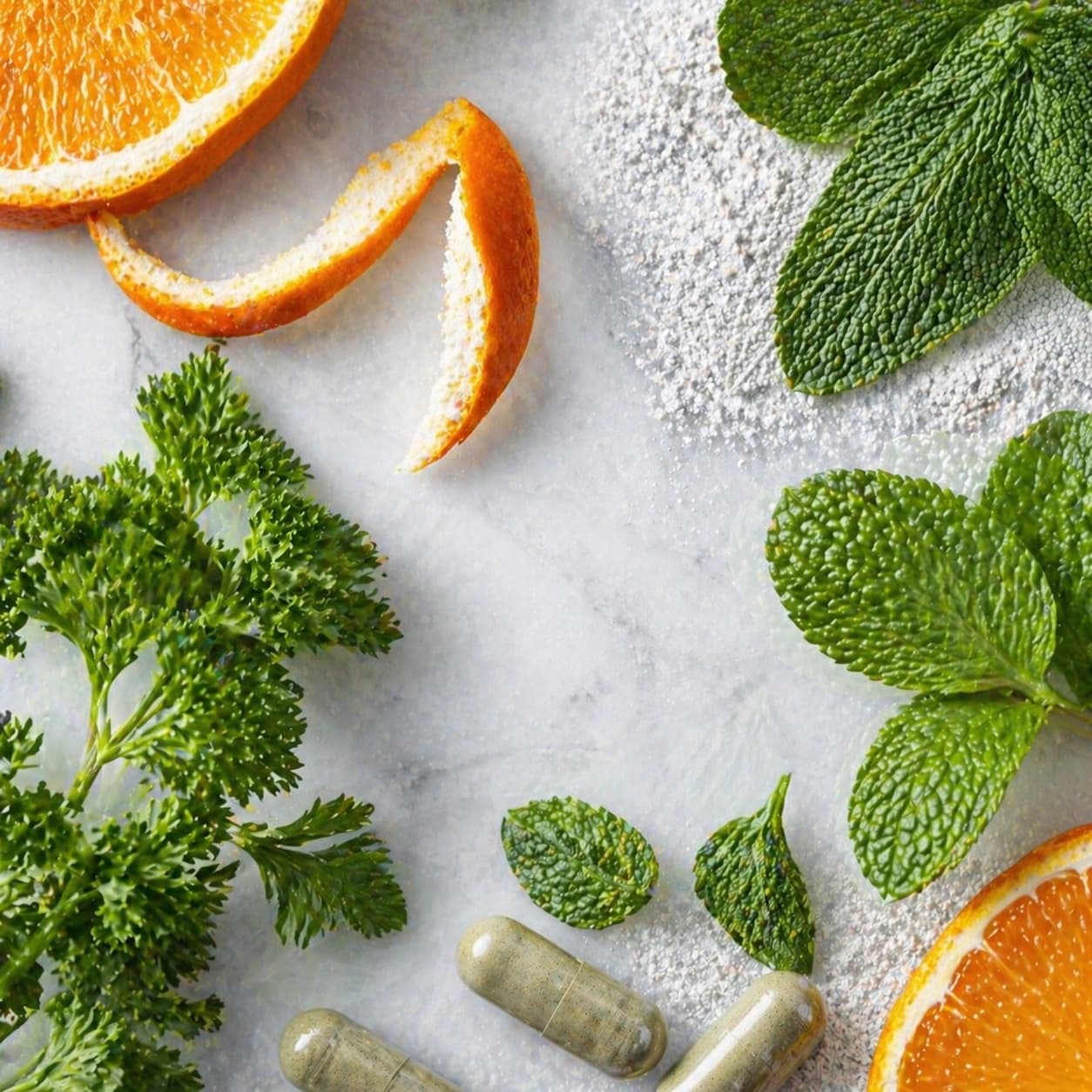 Parsley, peppermint and citrus peel on cool stone